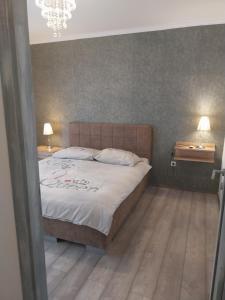 a bedroom with a large bed and two tables at Vila Brig 108 - private swimming pool and jacuzzi in Rijeka +34 photos