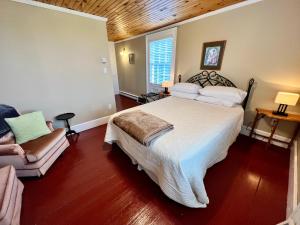 a bedroom with a large bed and a couch at Bishop White Manor in Trinity