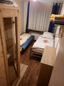 a small room with two beds and a window at C. Leuci in Hannover