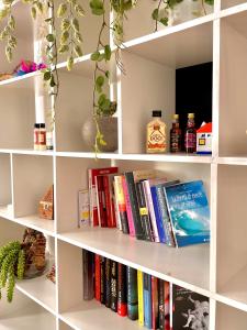 een witte boekenplank gevuld met boeken bij SanZenoHome StayInVerona Full Apartment in Verona