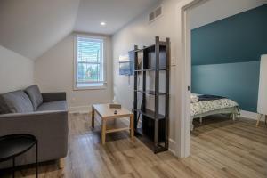 a living room with a couch and a bed at One Bedroom Apartment - 3 Minutes from Downtown in Ottawa