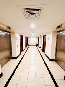 an empty hallway of an office building with elevators at The Aero Vacation Homes in Dubai
