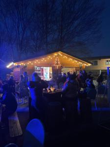 a group of people sitting at a party in the dark at Residence Cimone SuperSci Polle-life in Riolunato
