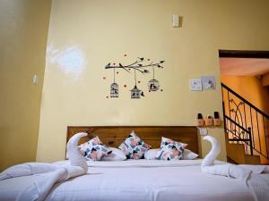 a bedroom with two beds with white sheets and swan antlers at Daffodils Guest House Calangute in Calangute