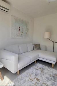 a white couch sitting in a living room at Appartement Tara in Malinska