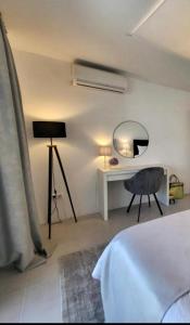 a bedroom with a bed and a desk and a mirror at Appartement Tara in Malinska +28 photos