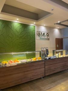a buffet line in a restaurant with a fish tank at Hotel Mocawa Plaza Armenia in Armenia