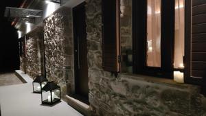 a chair in a room with a stone wall at Nafplio Village in Nafplio +97 photos