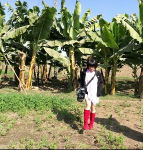 a young girl standing in front of a banana plantation at Dream Garden Luxor in Luxor