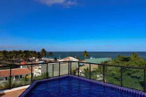 a view from the balcony of a resort with a swimming pool at Flat Kandela - Maracaípe in Porto De Galinhas