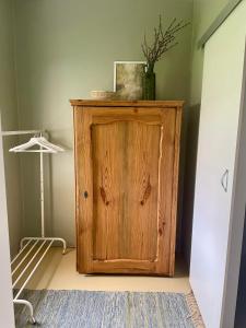 un armario de madera en la esquina de una habitación en Patika Vendeghaz, en Őriszentpéter