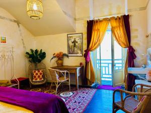 a bedroom with a bed and a desk and a window at Les Contes in Fougax-et-Barrineuf