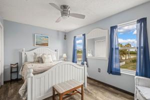 a bedroom with a white bed and a window at Lucky Enough in Gulf Shores