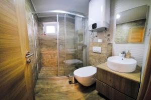 a bathroom with a shower and a toilet and a sink at Villa Montemaris Budva in Budva
