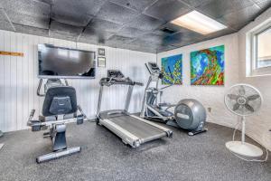a gym with cardio equipment in a room at Beach House Condominiums B101 - Beachfront with Pool, WiFi, & Beach Service in Destin