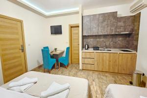 a hotel room with two beds and a kitchen at Villa Montemaris Budva in Budva