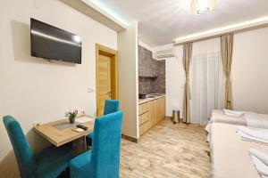 a living room with a table and chairs and a bed at Villa Montemaris Budva in Budva