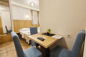 a room with a table and chairs and a bed at Villa Montemaris Budva in Budva