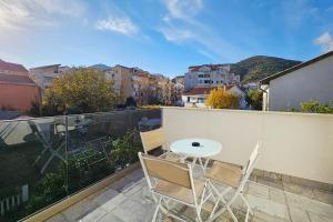 a patio with a table and chairs on a balcony at Villa Montemaris Budva in Budva