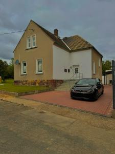 a black car parked in front of a house at Villa Affenhaus in Treben