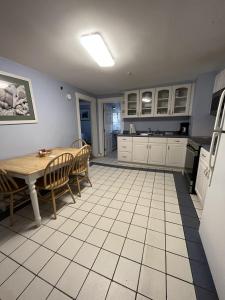 a kitchen with a table and a table and chairs at Beau Rivage Motel in Old Orchard Beach