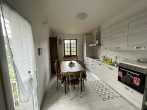 a kitchen with a table and a dining room at La casa di Rosetta in Levanto