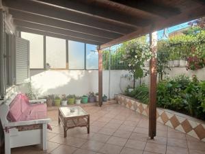 a patio with potted plants and a table at Goni Guest House in Sarandë