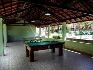 two pool tables sitting inside of a building at Vila Francesa Hotel in Penedo