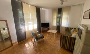 a living room with a television and a table and chairs at Wohnung mit Charme in Munich