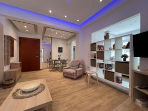 a living room with a couch and a table at Raise Varkiza Serenity Suite in Vari
