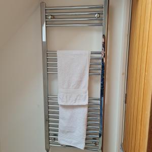 a towel rack in a refrigerator with some towels at Large Double Room with Ensuite and double shower - Homestay in Bishops Frome