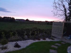 a garden with a wooden shed in a field at Close to Lough Rynn Castle Mohill - Room Only in Mohill