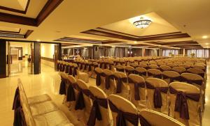 a large hall with chairs and tables in it at Lake Palace Trivandrum in Vettutura +73 photos