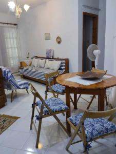 a living room with a table and chairs and a couch at Kamari Beach guest house in Keramídhion