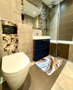 a bathroom with a toilet and a sink and a shower at The Kings Palace Central London by Wild in London