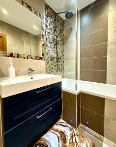 a bathroom with a sink and a shower and a tub at The Kings Palace Central London by Wild in London