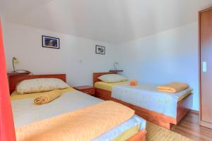 Postel nebo postele na pokoji v ubytování VILLA JELA
