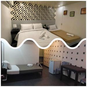 a bedroom with a large white bed and a table at ACME Inn Subic in Olongapo