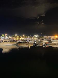 a group of boats docked in a marina at night at Marina Saidia AP8 LILIA in Saïdia