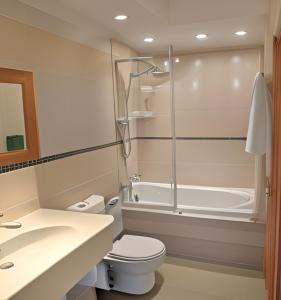 a bathroom with a toilet and a bath tub at Golden Lion Hotel in Rugby