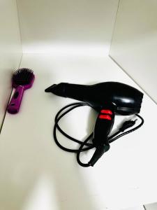 a hair dryer and a hair brush on a counter at Улица Абая 52 in Sätbaev