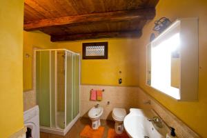 a bathroom with a sink and a toilet and a shower at La Mimosa Case Vacanze in Marsala