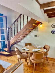 a dining room with a wooden table and a staircase at Erietta Suites in Chania Town