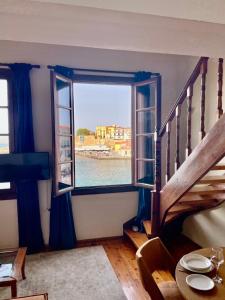 a room with a window and a table and a staircase at Erietta Suites in Chania Town