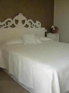 a white bed with white sheets and pillows at B&B Rosalu - Adults Only in Sirmione