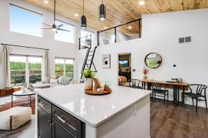 a kitchen and living room with white walls and windows at Mountain and Pond View, HotTub, Stars, Kid and Dog Friendly in Florissant