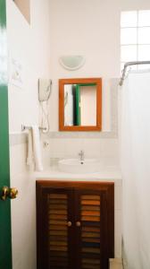 a bathroom with a sink and a mirror at Hotel Casa Amelia in Flores