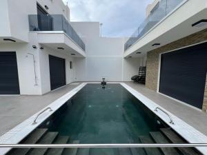 a swimming pool in the middle of a house at Elegant Villa with Pool in Gournes