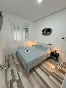 a bedroom with a bed and a table and a window at Alojamiento Fantasía in Madrid