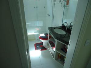 ein Badezimmer mit Waschbecken und Toilette in der Unterkunft A15 - APARTAMENTO 2 DORMITÓRIOS NO CENTRO DE BOMBINHAS ALUGUEL DE TEMPORADA in Bombinhas + 6 Fotos